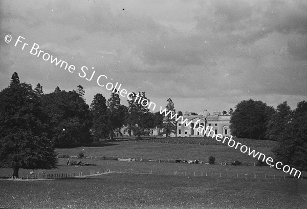 DISTANT VIEW OF HOUSE IN HARVEST TIME